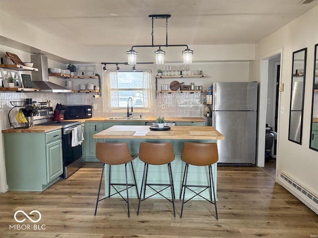 kitchen featuring open shelves, a baseboard radiator, butcher block counters, appliances with stainless steel finishes, and a sink