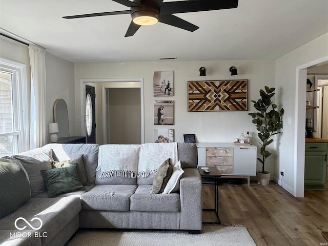 living room with ceiling fan and wood finished floors