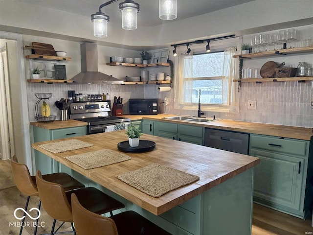 kitchen featuring green cabinets, open shelves, and butcher block countertops