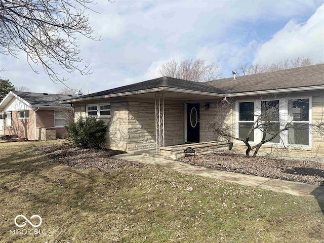 ranch-style house with stone siding and a front lawn