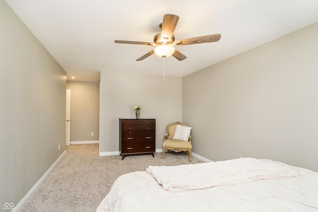 bedroom with ceiling fan, baseboards, and light colored carpet