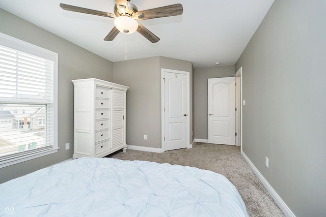 bedroom featuring carpet flooring, a ceiling fan, and baseboards