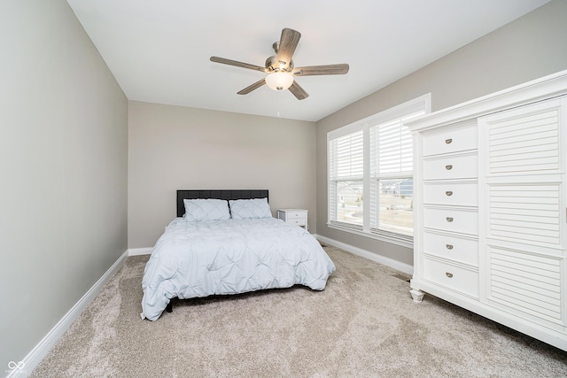 bedroom with ceiling fan, carpet flooring, and baseboards