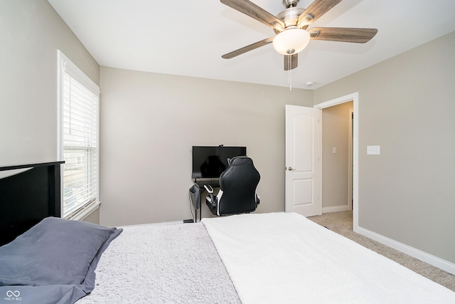 bedroom featuring light colored carpet, ceiling fan, and baseboards