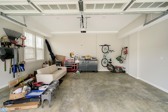 garage with baseboards and a garage door opener