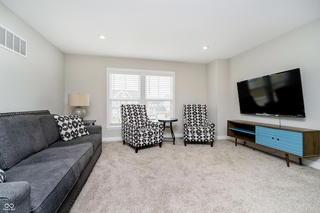 carpeted living room with baseboards, visible vents, and recessed lighting