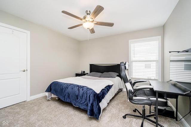 carpeted bedroom featuring a ceiling fan and baseboards