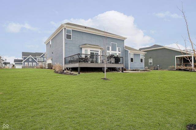 back of property with a lawn and a wooden deck