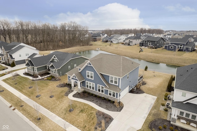 bird's eye view featuring a water view and a residential view