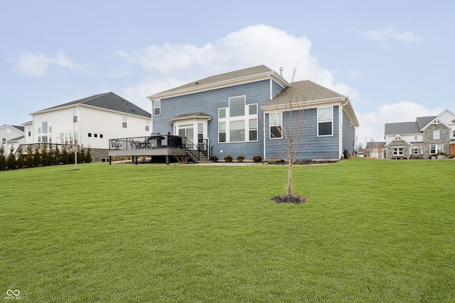 back of property featuring a yard and a wooden deck