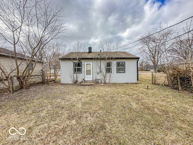 rear view of property with a yard