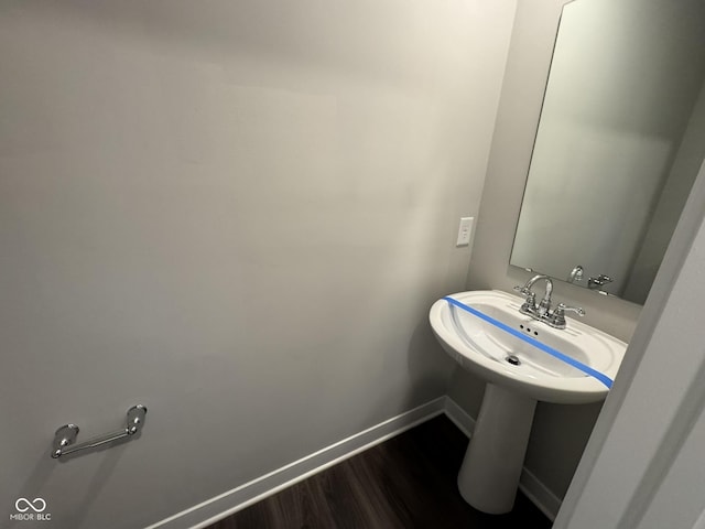 bathroom featuring baseboards and wood finished floors