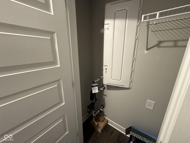 washroom with wood finished floors and baseboards