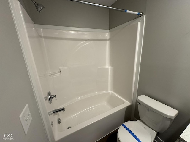 bathroom with tub / shower combination and toilet