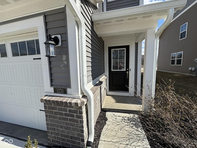 view of exterior entry featuring a garage