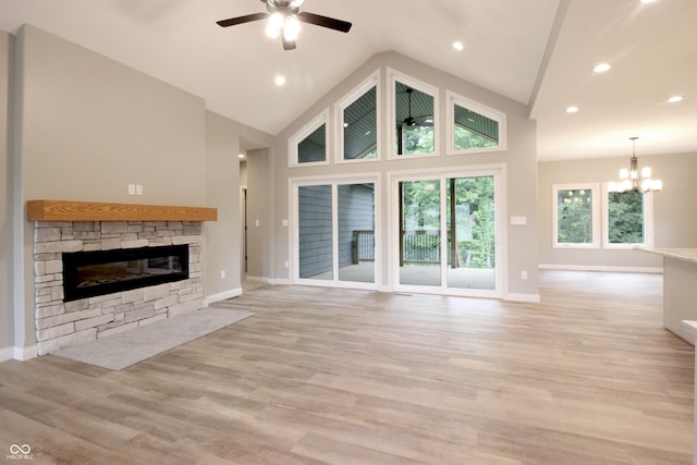 3604 Maple Ridge Dr, Columbus, IN 47201 - unfurnished living room featuring ceiling fan, high vaulted ceiling, a chandelier, a fireplace, and baseboards