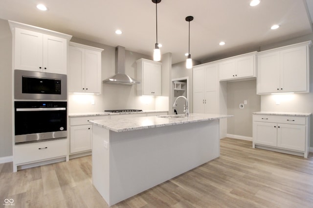 3604 Maple Ridge Dr, Columbus, IN 47201 - kitchen featuring wall chimney range hood, a sink, white cabinets, and recessed lighting