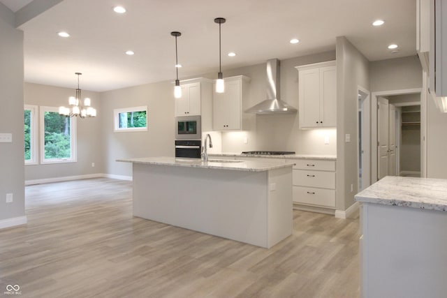3604 Maple Ridge Dr, Columbus, IN 47201 - kitchen with wall chimney range hood, light wood finished floors, baseboards, stainless steel microwave, and recessed lighting