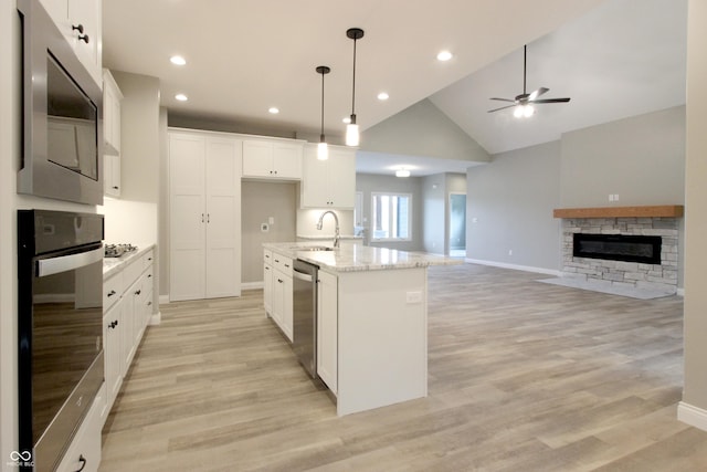 3604 Maple Ridge Dr, Columbus, IN 47201 - kitchen featuring stainless steel appliances, a sink, ceiling fan, white cabinetry, and light wood finished floors