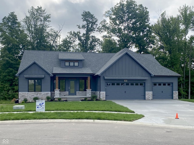 3604 Maple Ridge Dr, Columbus, IN 47201 - view of front facade with stone siding, board and batten siding, and a garage