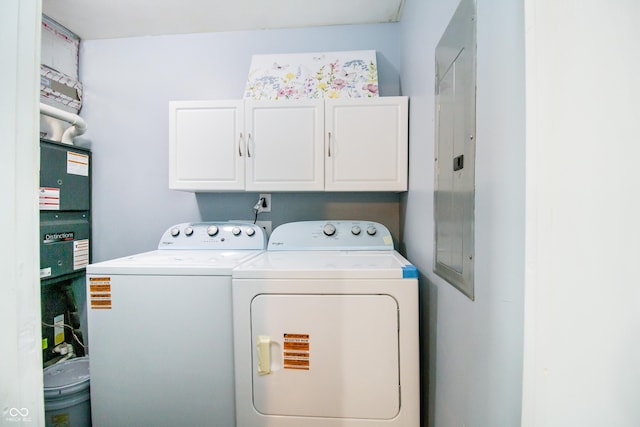 laundry room with separate washer and dryer and cabinet space