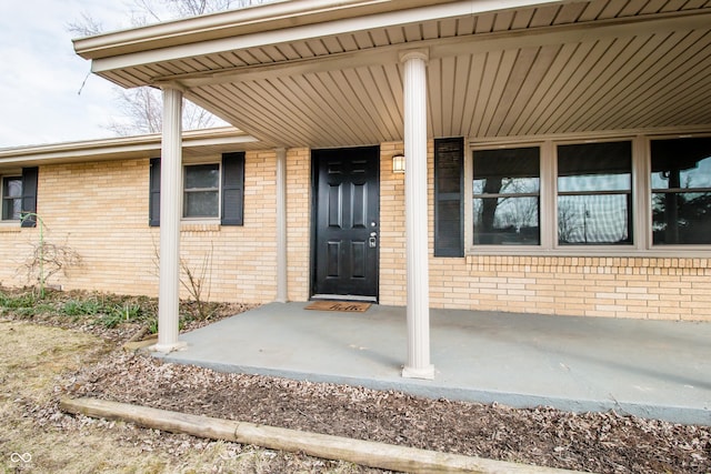 property entrance with brick siding