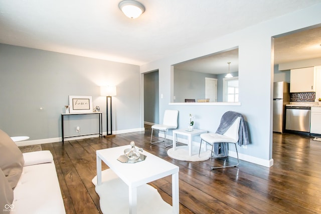 living area featuring baseboards and hardwood / wood-style floors