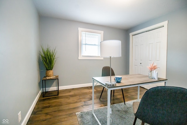 office space with baseboards and wood finished floors