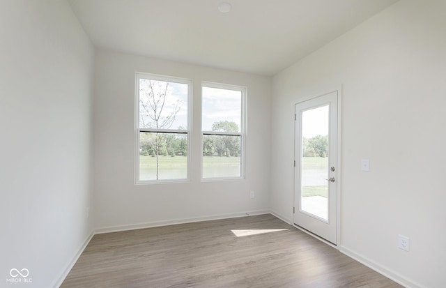 entryway with wood finished floors and baseboards