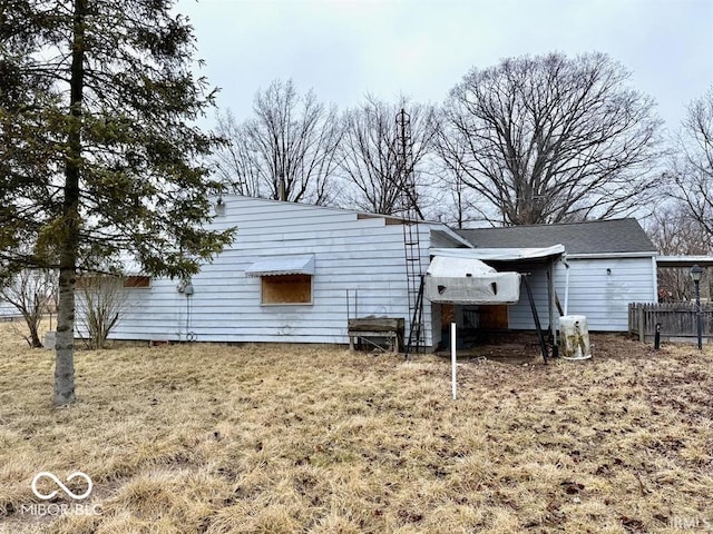 back of house featuring fence