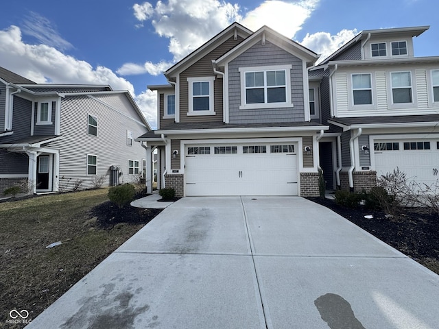 view of front of house with driveway, brick siding, and an attached garage