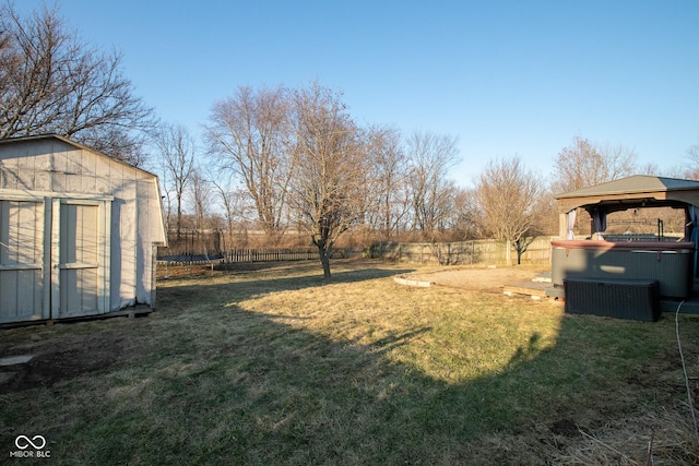 view of yard featuring a storage shed, a fenced backyard, a trampoline, a gazebo, and an outdoor structure