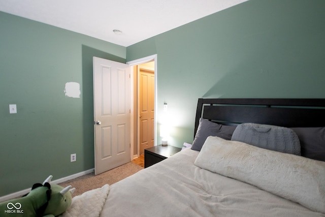 carpeted bedroom with baseboards