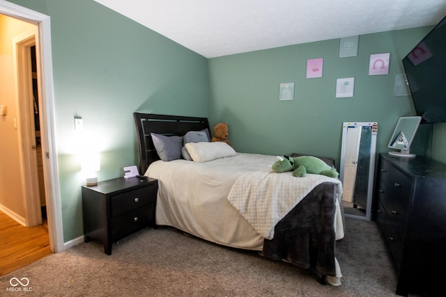 bedroom with carpet flooring and baseboards