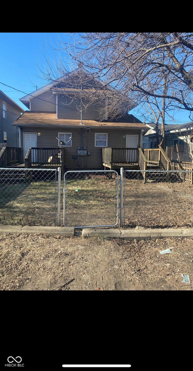 view of front of house featuring a fenced front yard and a gate