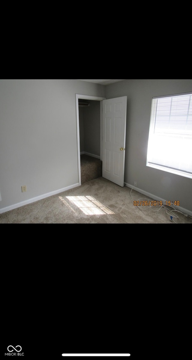 unfurnished bedroom featuring carpet flooring and baseboards