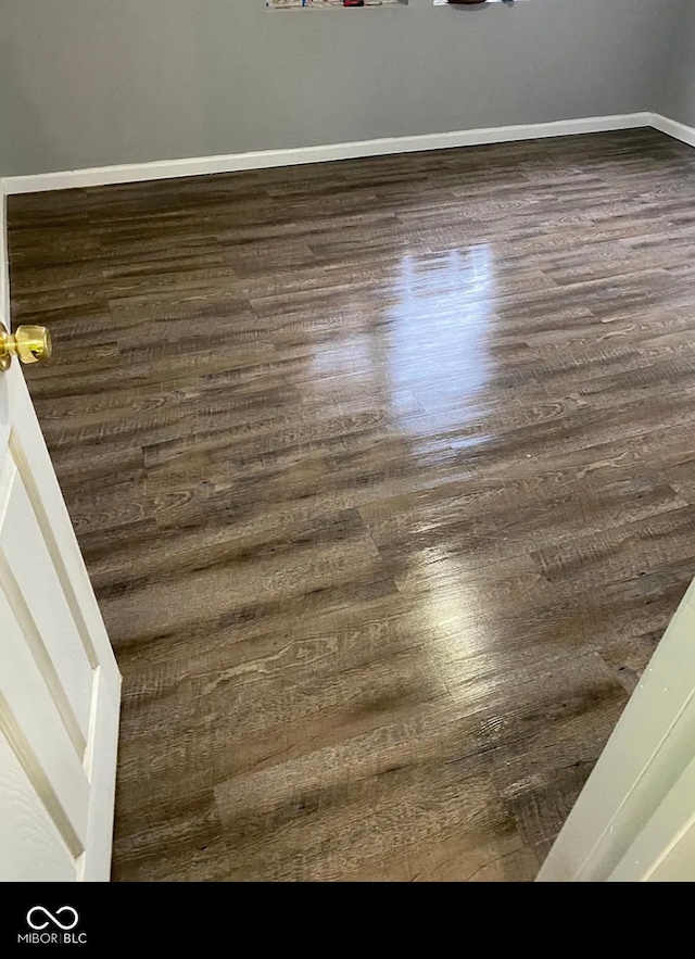 interior details featuring baseboards and wood finished floors