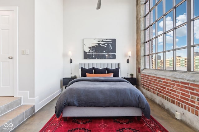 bedroom with baseboards and concrete floors