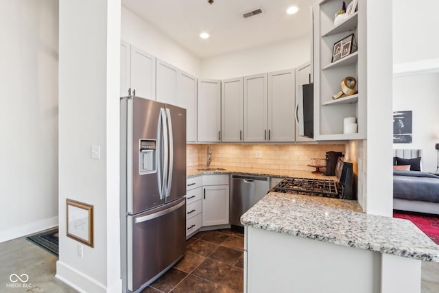 kitchen featuring visible vents, a sink, decorative backsplash, stainless steel appliances, and open shelves