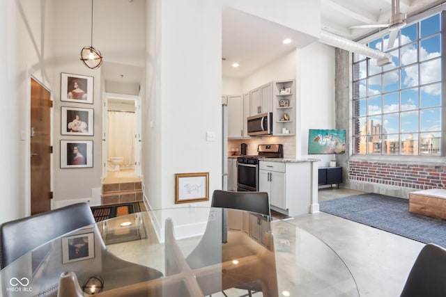 dining room featuring recessed lighting and concrete flooring