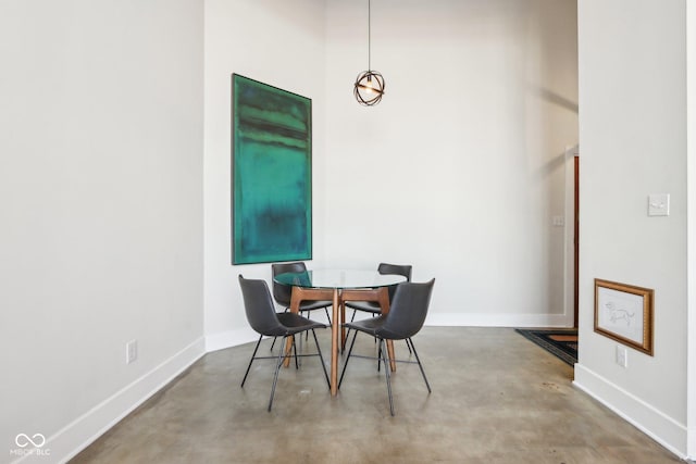 dining area with concrete floors and baseboards