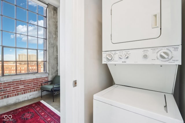 laundry area with stacked washer / dryer and laundry area