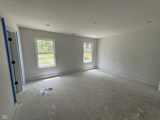 565 Mill Spgs, Coatesville, IN 46121 - empty room featuring baseboards, a textured ceiling, and concrete flooring