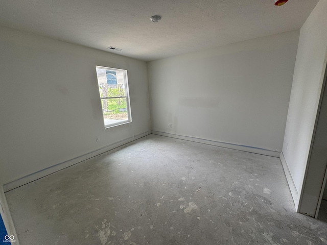 565 Mill Spgs, Coatesville, IN 46121 - empty room with concrete floors, baseboards, and a textured ceiling