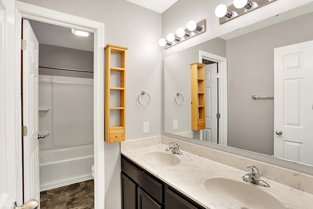 full bathroom with double vanity, shower / tub combination, a sink, and toilet