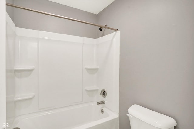 bathroom featuring shower / tub combination and toilet