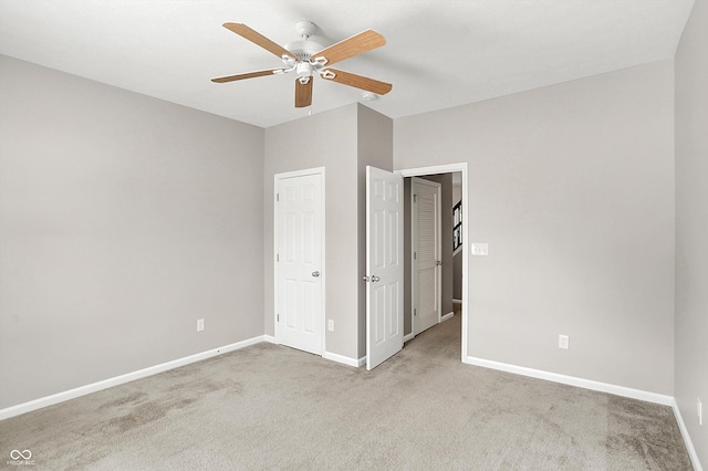 unfurnished bedroom with carpet floors, baseboards, and a ceiling fan