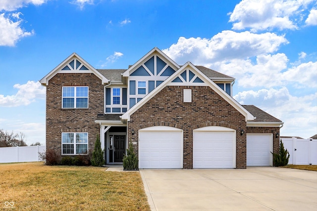 view of front of property featuring an attached garage, brick siding, fence, driveway, and a front yard