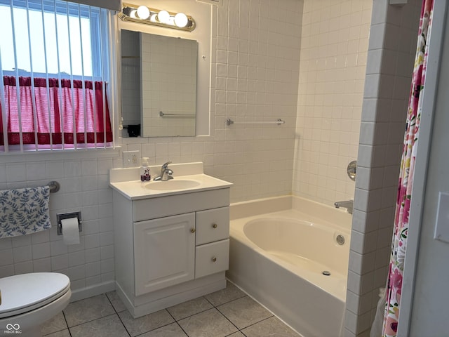 full bathroom featuring tile walls, shower / bath combination with curtain, toilet, vanity, and tile patterned flooring