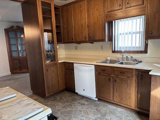 kitchen featuring open shelves, white dishwasher, a sink, and light countertops